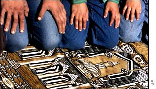 British Muslims pray on a rug made up of a picture image of the al-Aqsa Mosque in Jerusalem